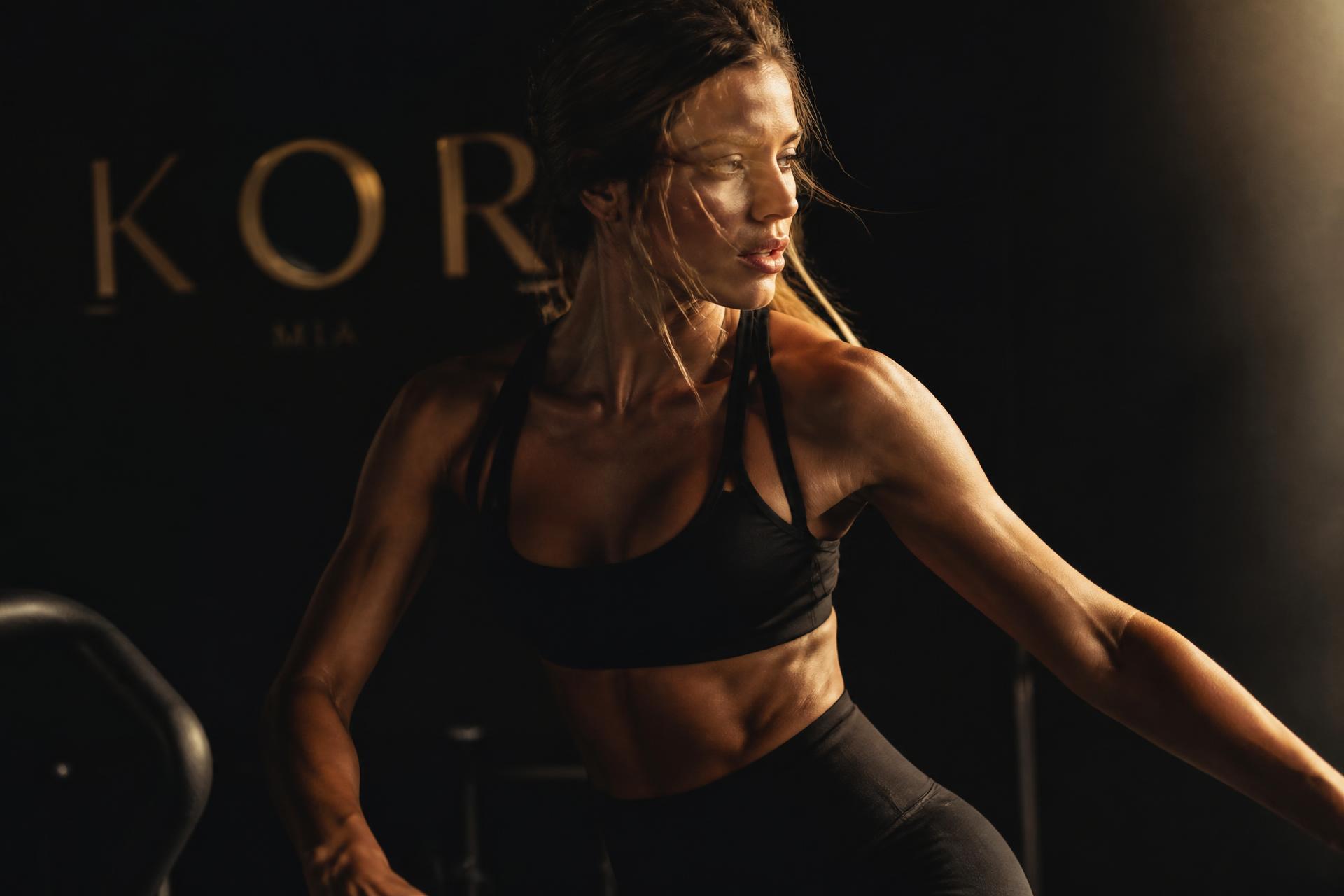 Athletic woman in a moody fitness studio